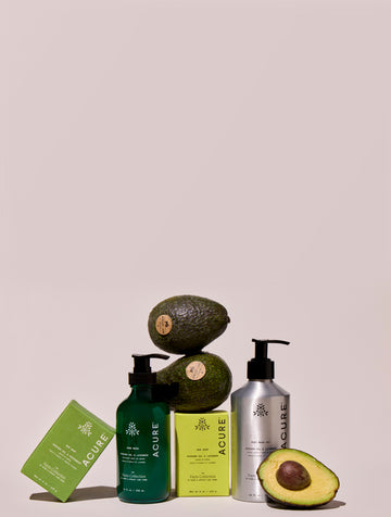 Acure skincare products with avocados on a beige background